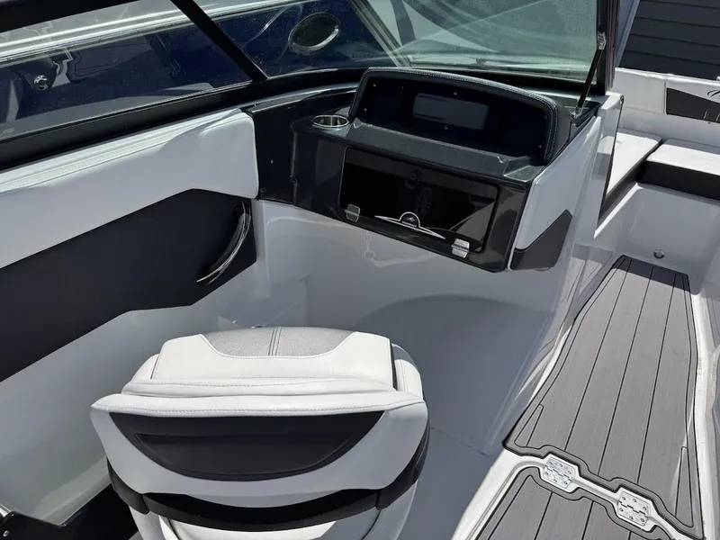 Slide: The Image of 2022 Monterey M225 boat interior with helm station and seating. - 5