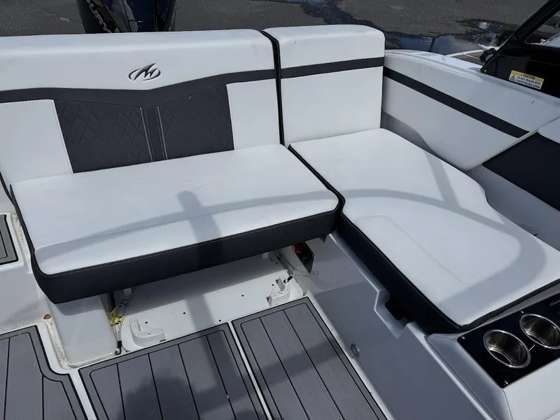 Slide: The Image of 2022 Monterey M225 boat interior seating with white and black upholstery. - 8