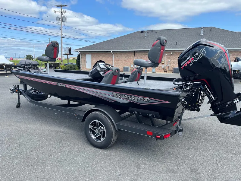 Slide: The Image of 2024 Ranger RT188 boat with trailer, featuring a sleek black design and powerful outboard motor. - 10
