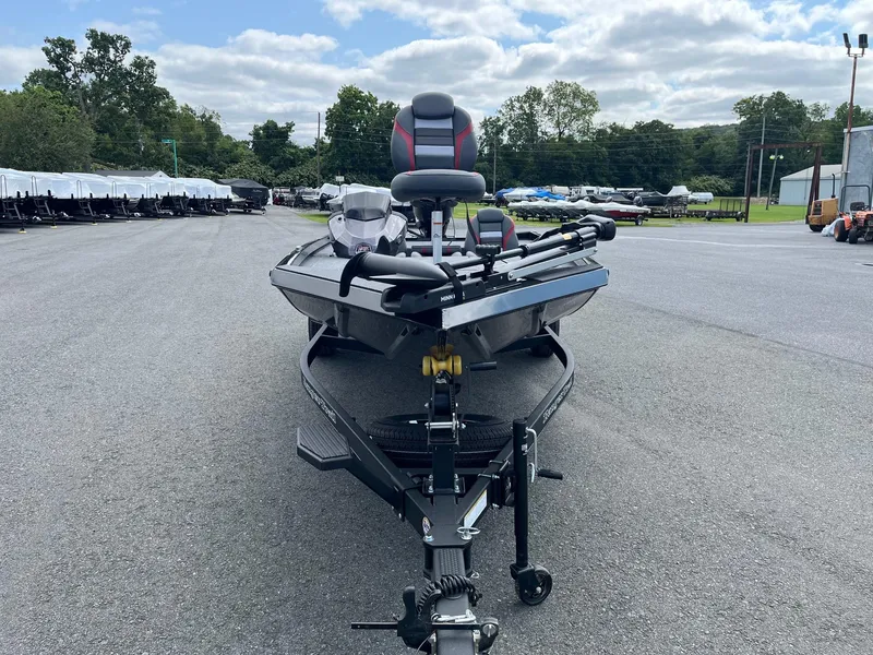Slide: The Image of 2024 Ranger RT188 boat on trailer in outdoor lot, under cloudy sky. - 5