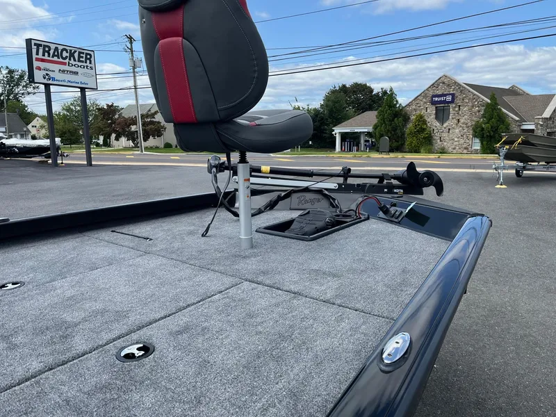 Slide: The Image of 2024 Ranger RT188 boat deck with seat and trolling motor, parked outdoors. - 8