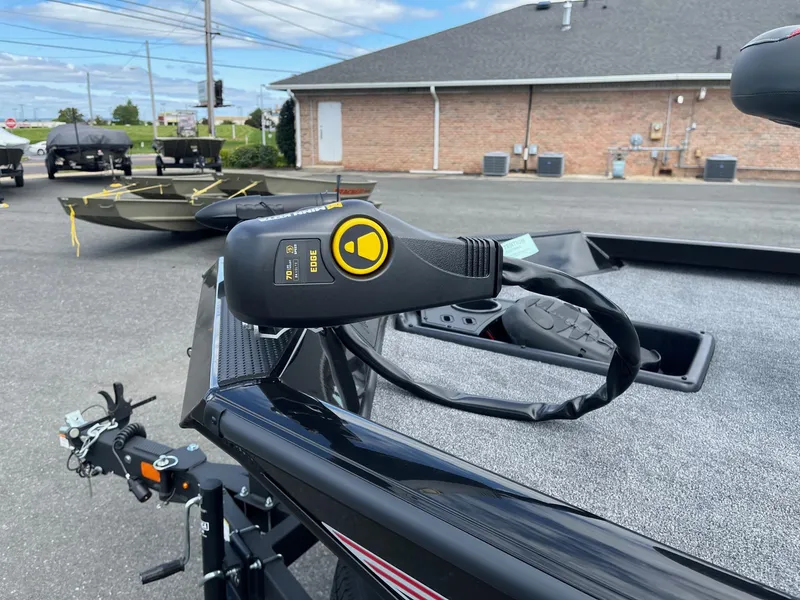 Slide: The Image of 2024 Ranger RT188 boat with trolling motor in a parking lot. - 9