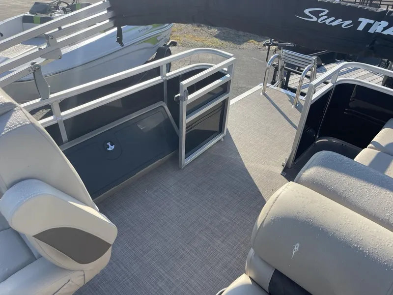 Slide: The Image of 2024 Sun Tracker Sportfish 24 XP3 pontoon boat interior with seating and railing. - 11