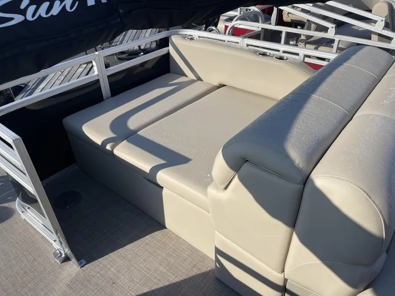 Slide: The Image of 2024 Sun Tracker Sportfish 24 XP3 boat with beige seating and metal railings. - 12