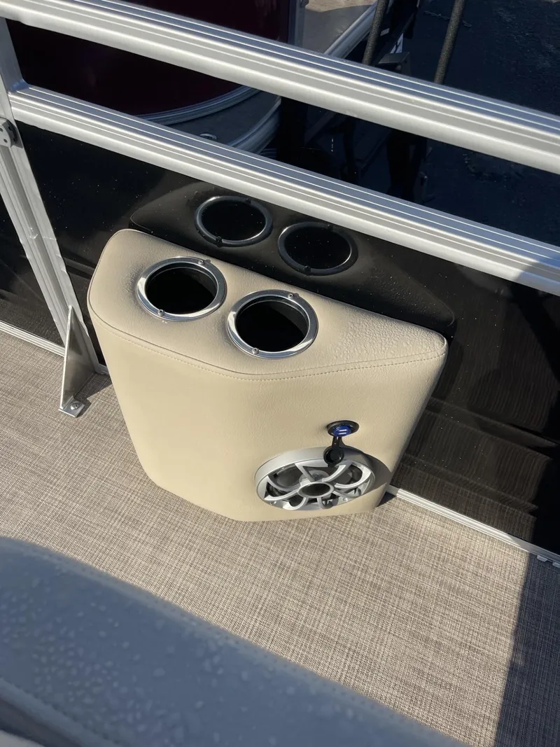 Slide: The Image of 2024 Sun Tracker Sportfish 24 XP3 cup holders and speaker on boat deck. - 14