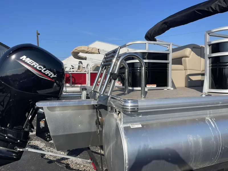 Slide: The Image of 2024 Sun Tracker Sportfish 24 XP3 pontoon boat with Mercury engine, rear view. - 4