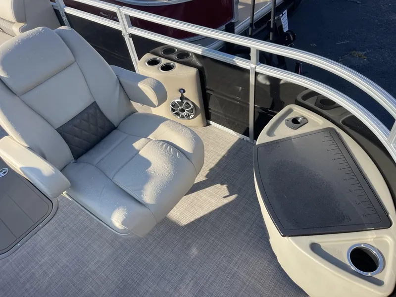 Slide: The Image of 2024 Sun Tracker Sportfish 24 XP3 boat interior with comfortable seating and cup holders. - 6