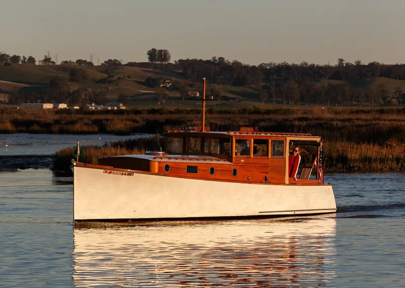 Slide: The Image of Vintage 1929 Stephens Brothers 34 Trunk Cabin Cruiser on serene waterway at sunset. - 0