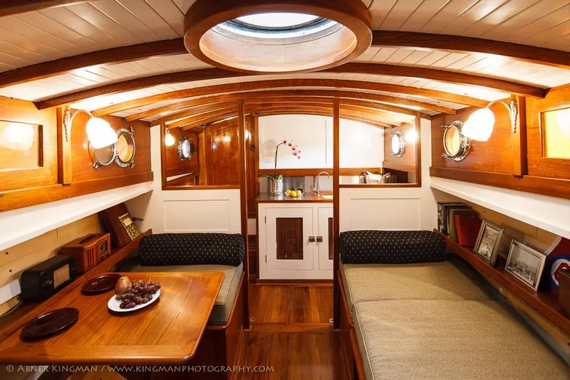 Slide: The Image of Interior of 1929 Stephens Brothers 34 Trunk Cabin Cruiser, featuring wood paneling and cozy seating. - 11