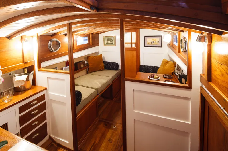Slide: The Image of Interior of 1929 Stephens Brothers 34 Trunk Cabin Cruiser with wooden finishes and cozy seating. - 12