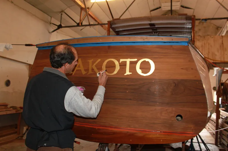 Slide: The Image of Man painting name on 1929 Stephens Brothers 34 Trunk Cabin Cruiser in workshop. - 16