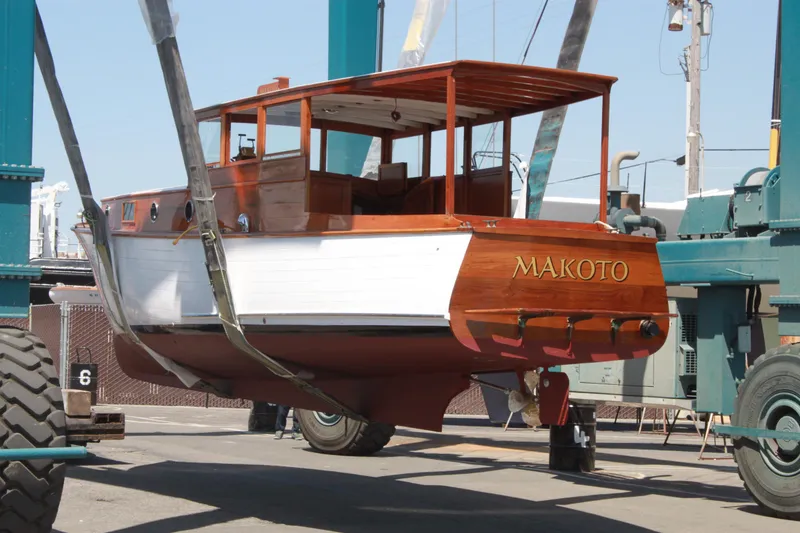 Slide: The Image of 1929 Stephens Brothers 34 Trunk Cabin Cruiser "Makoto" being lifted at a marina. - 20