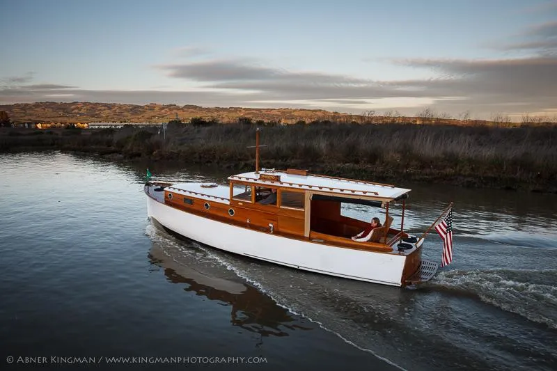 Slide: The Image of 1929 Stephens Brothers 34 Trunk Cabin Cruiser on serene water at sunset. - 4