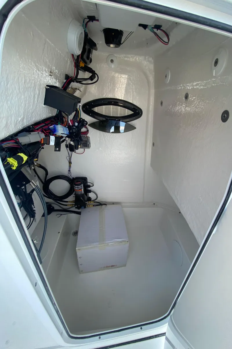 Slide: The Image of 2024 Sea Pro 222 Center Console interior wiring and storage compartment. - 12