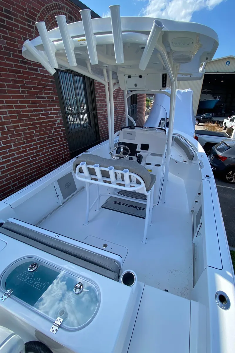 Slide: The Image of 2024 Sea Pro 222 Center Console boat with T-top and rod holders. - 3