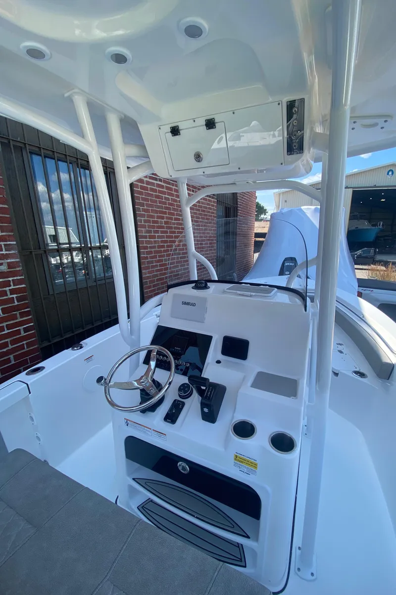 Slide: The Image of 2024 Sea Pro 222 Center Console boat interior with steering wheel and control panel. - 4