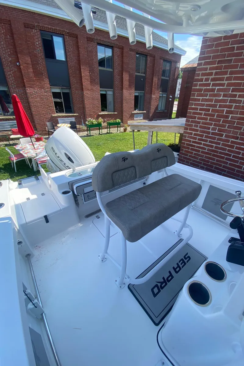 Slide: The Image of 2024 Sea Pro 222 Center Console boat interior with seating and rod holders. - 6