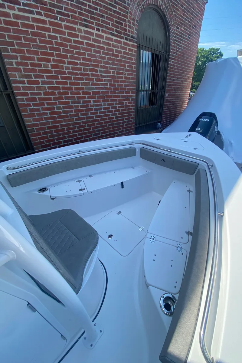 Slide: The Image of 2024 Sea Pro 222 Center Console boat interior with seating and storage compartments. - 8