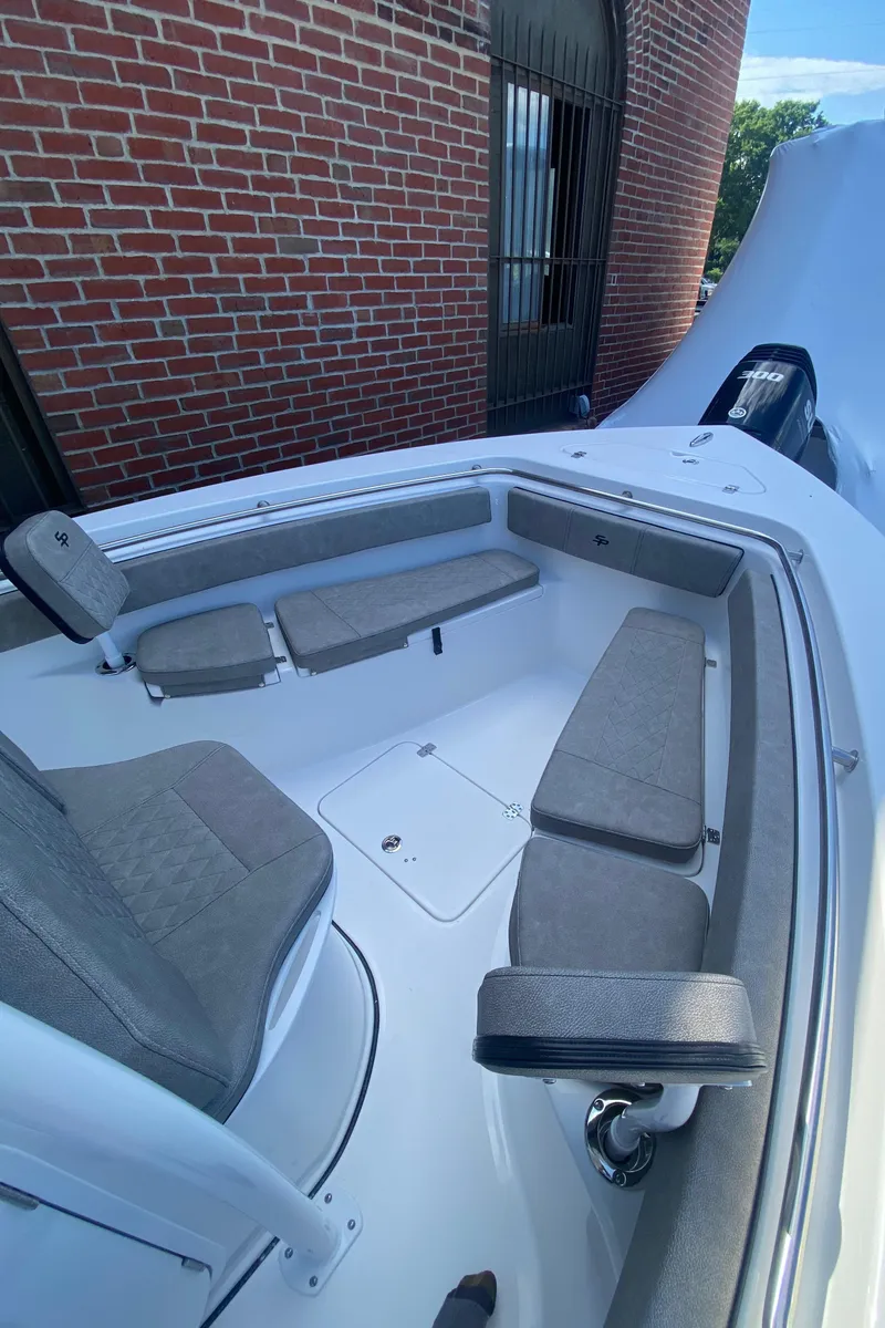 Slide: The Image of 2024 Sea Pro 222 Center Console boat with cushioned seating and storage compartments. - 9