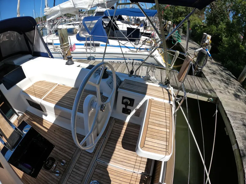 Slide: The Image of 2019 Hanse 388 yacht cockpit with wooden deck and steering wheel at marina. - 10
