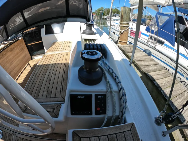 Slide: The Image of Hanse 388 sailboat cockpit, 2019 model, featuring teak decking and winch system at marina. - 11