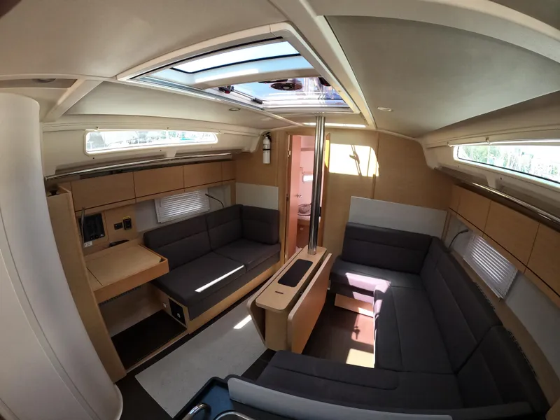 Slide: The Image of Interior of 2019 Hanse 388 yacht with modern seating and natural light. - 20