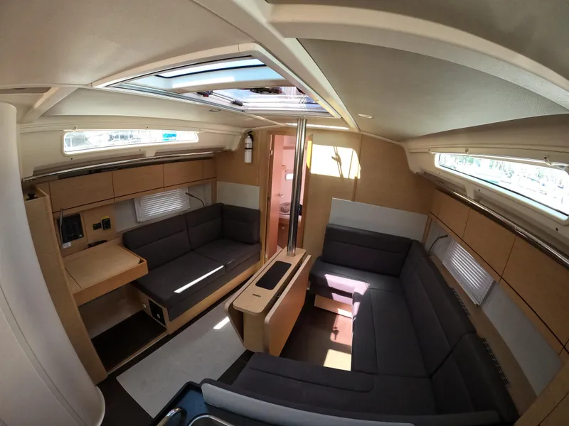 Slide: The Image of Interior of 2019 Hanse 388 yacht, featuring modern seating and natural light. - 21