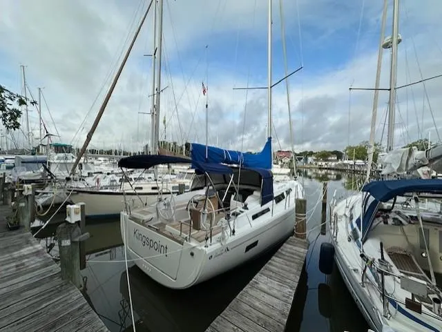Slide: The Image of 2019 Hanse 388 sailboat docked in a marina, surrounded by other boats. - 3