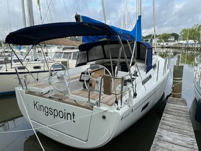 Slide: The Image of 2019 Hanse 388 sailboat "Kingspoint" docked at marina with blue canopy. - 4