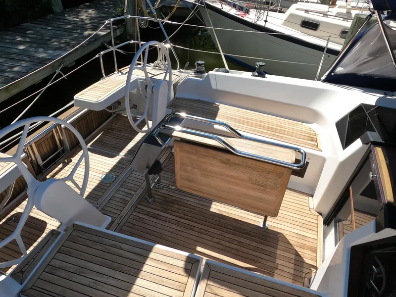 Slide: The Image of 2019 Hanse 388 yacht cockpit with dual steering wheels and teak flooring. - 8