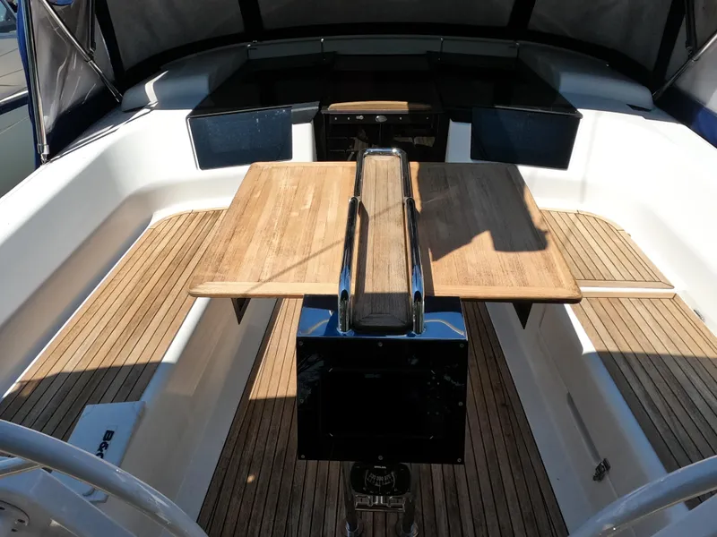 Slide: The Image of Spacious cockpit of 2019 Hanse 388 sailboat with wooden table and seating. - 9