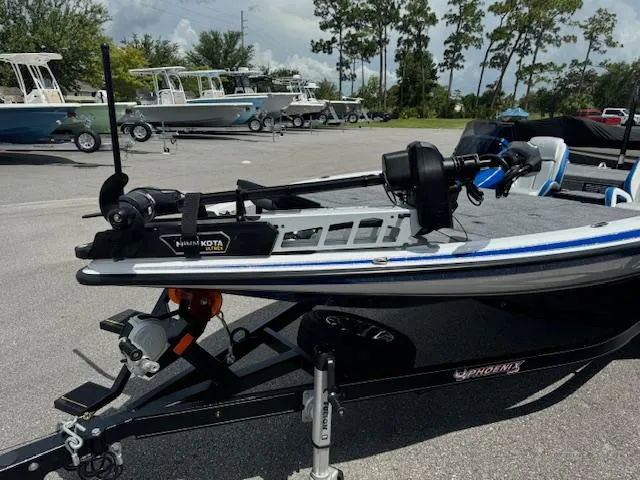 Slide: The Image of 2025 Phoenix 920 Elite 2 boat on trailer with Minn Kota trolling motor. - 2
