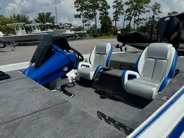 Slide: The Image of Phoenix 920 Elite 2 boat interior, 2025 model, featuring blue and gray seats and steering console. - 7