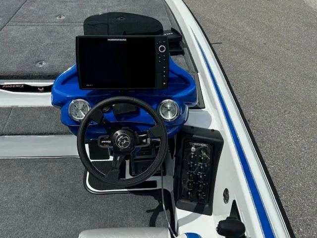 Slide: The Image of 2025 Phoenix 920 Elite 2 boat dashboard with steering wheel and navigation system. - 8