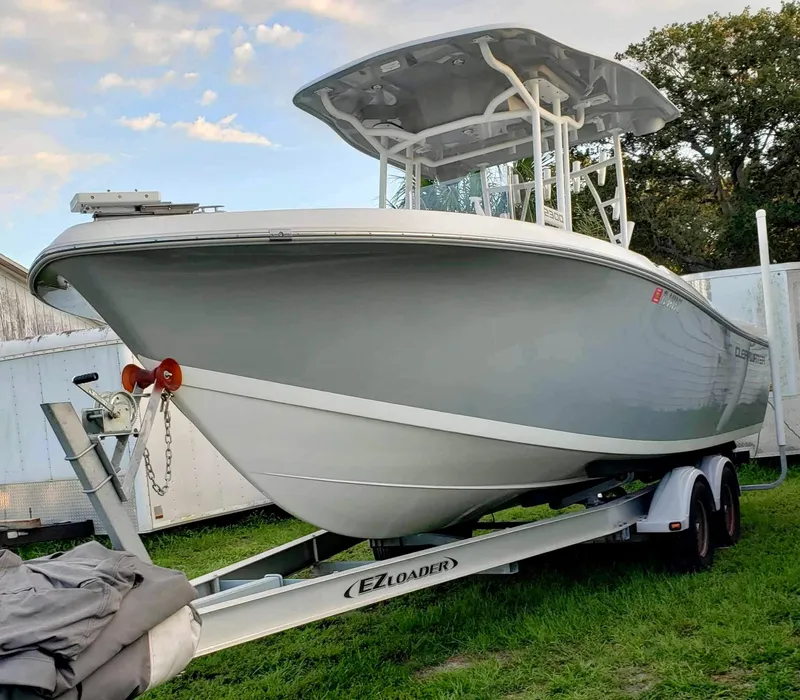 The Image of 2022 Clearwater 2300 boat on EZ Loader trailer, parked on grass. - 1