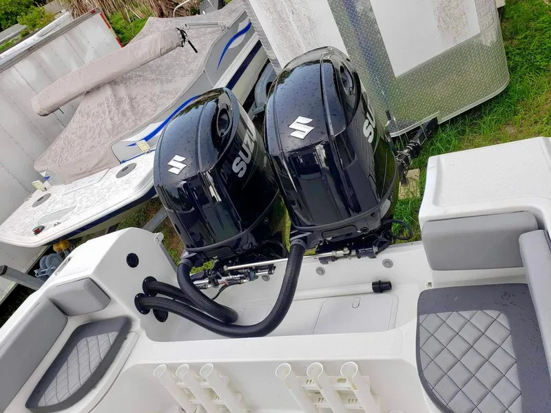 Slide: The Image of Twin Suzuki outboard motors on a 2022 Clearwater 2300 boat, featuring a sleek design. - 12