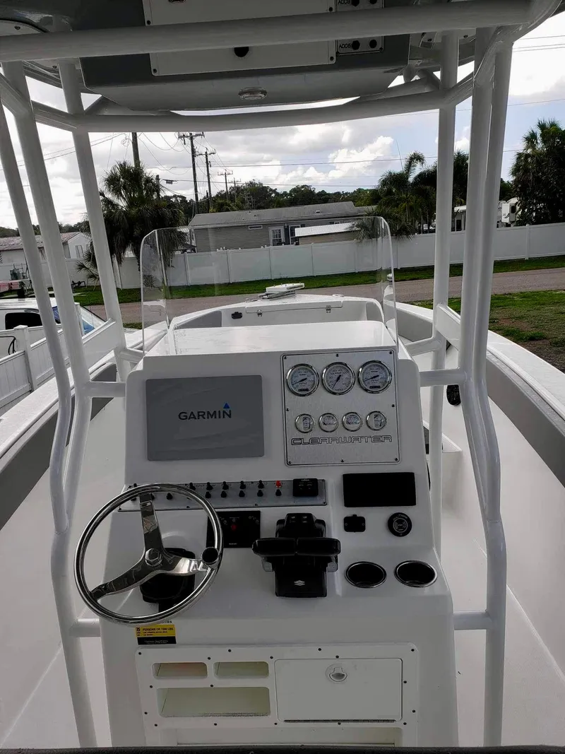 Slide: The Image of 2022 Clearwater 2300 boat dashboard with Garmin display and steering wheel. - 17