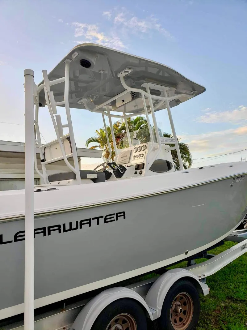 Slide: The Image of 2022 Clearwater 2300 boat on trailer, side view, with T-top and console. - 3