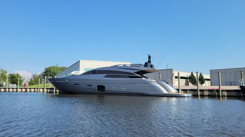 Slide: The Image of 2017 Pershing 92 Motor Yacht docked by industrial buildings on a sunny day. - 0