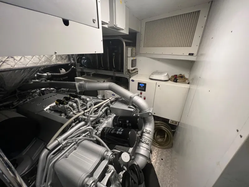 Slide: The Image of Engine room of 2017 Pershing 92 Motor Yacht, showcasing complex machinery and equipment. - 17