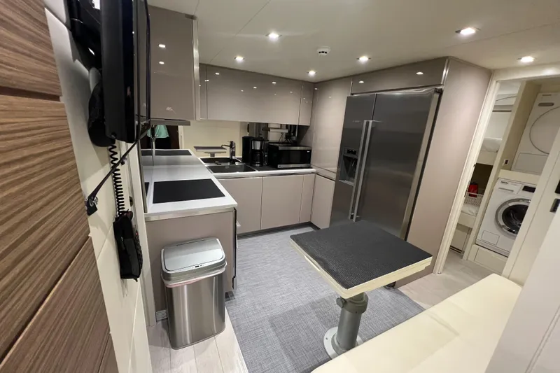 Slide: The Image of Modern kitchen interior of 2017 Pershing 92 Motor Yacht with sleek appliances and dining area. - 19