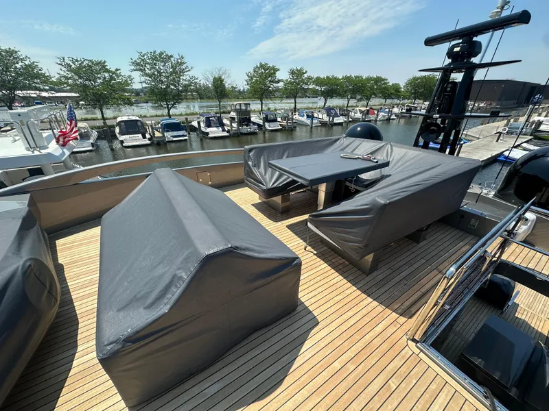 Slide: The Image of 2017 Pershing 92 Motor Yacht deck with covered seating, docked at marina. - 24