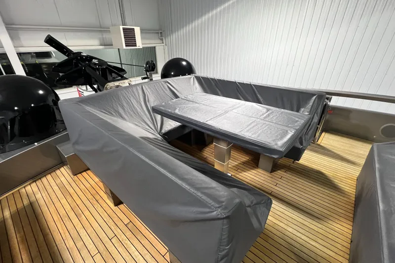 Slide: The Image of 2017 Pershing 92 Motor Yacht deck with covered seating and table. - 27
