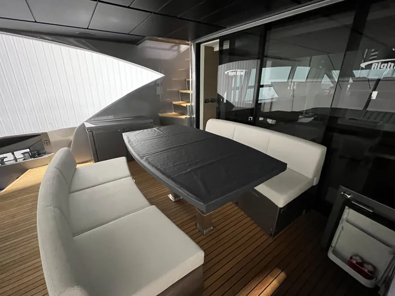 Slide: The Image of Luxurious 2017 Pershing 92 Motor Yacht interior with elegant seating and dining area. - 29
