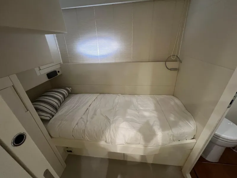 Slide: The Image of Compact bedroom in 2017 Pershing 92 Motor Yacht with single bed and striped pillow. - 45