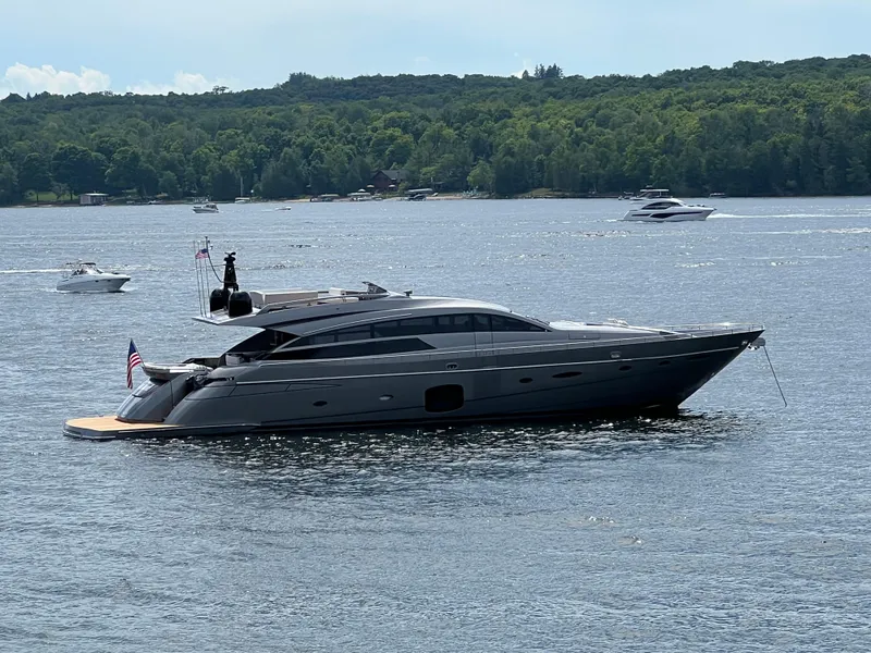 Slide: The Image of 2017 Pershing 92 Motor Yacht on a serene lake with lush green shoreline. - 5