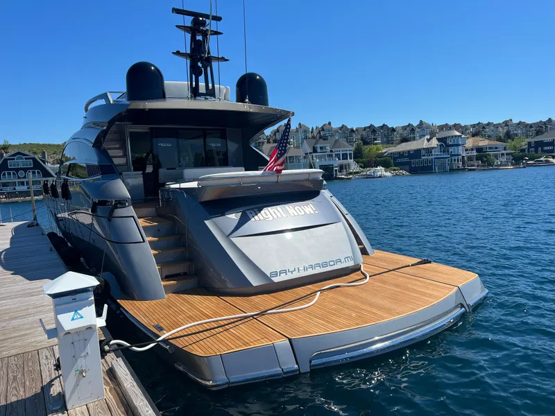 Slide: The Image of 2017 Pershing 92 Motor Yacht docked at a marina, with waterfront homes in the background. - 8