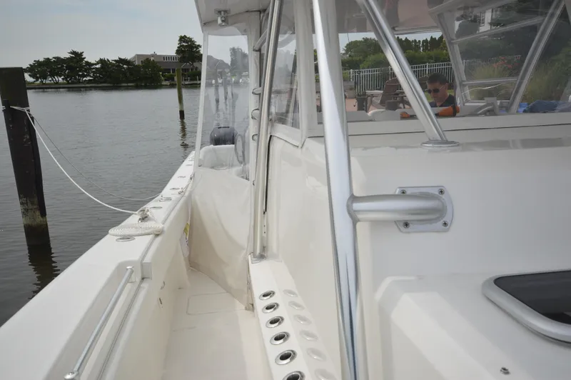 Slide: The Image of 2018 Invincible 43 Open Fisherman boat docked by the water. - 10