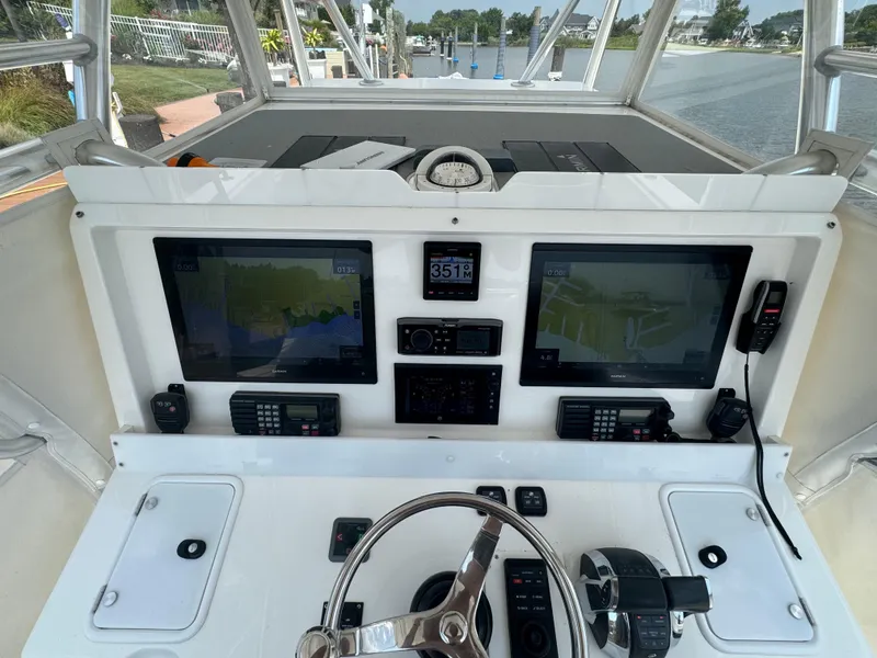 Slide: The Image of 2018 Invincible 43 Open Fisherman helm with dual navigation screens and controls. - 12