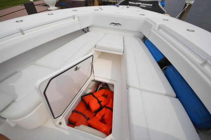 Slide: The Image of 2018 Invincible 43 Open Fisherman boat with open storage compartment containing life jackets. - 2